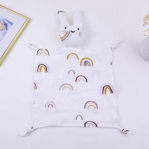 Detailed view of white cotton gauze baby comforter with rainbow pattern and bunny head