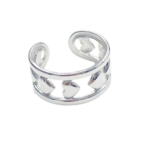 Close-up of heart-shaped hollow design on silver-tone stainless steel open ring