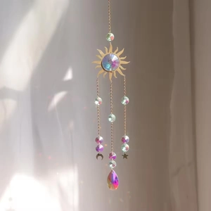 Golden sun and moon crystal suncatcher with prisms creating rainbow light reflections