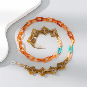 Close-up of colorful resin eyewear chain with amber, green, and orange acrylic links
