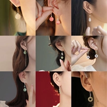 Detail showing various tassel earrings with Morandi-colored faux jade and quartz beads