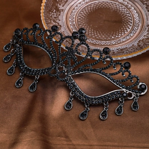Elegant black metal masquerade mask with sparkling rhinestones and teardrop pendants