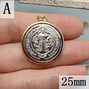 Macro detail of 25mm Saint Benedict medal pendant with silver religious relief and gold rim