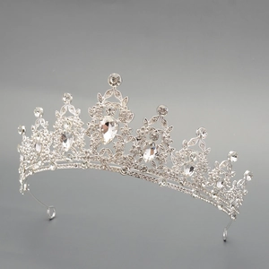 Close-up of luxury bridal crown with silver base and intricate crystal leaf patterns