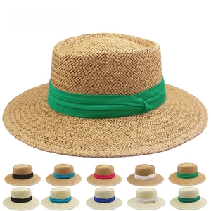 Detail view of straw sun hat textures and various colorful ribbon band options