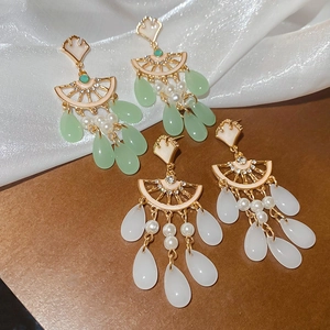 Close-up of vintage ginkgo leaf tassel earrings with rhinestones and waterdrop resin charms