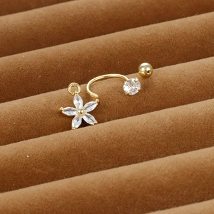 Golden flower C-ring piercing with zircon pendant shown on brown velvet background