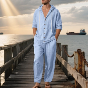 Detail of light blue linen hoodie shirt and matching beach pants set on boardwalk