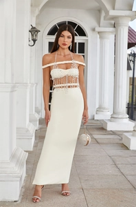 Detail of beaded tassel trim on cream off-shoulder evening gown with matching clutch
