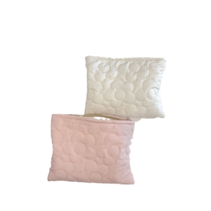 Quilted floral puffer cosmetic bags in white and pink with zip closure and plush texture