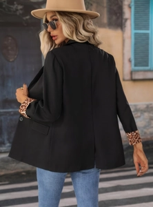 Detail of leopard print cuff lining on a premium black women's oversized blazer jacket