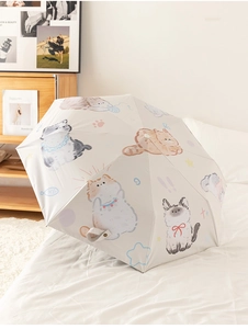 Detail of cute cartoon cat illustrations on a cream foldable sun and rain umbrella