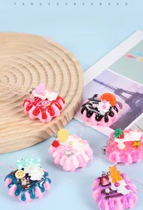 Macro view of realistic waffle cake keychains with imitation cream and fruit toppings
