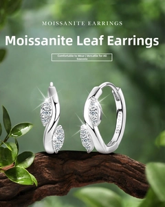 Close-up of S925 sterling silver leaf hoop earrings with moissanite on a branch