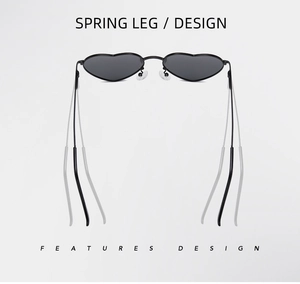 Detail of metal heart-shaped sunglasses featuring spring leg design and black lenses