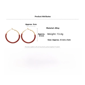 Detailed view of red enamel gold earrings showing 5cm diameter and alloy material specs