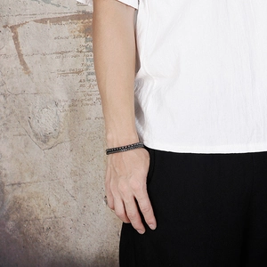 Men's double-layered Cuban chain bracelet in matte black finish with woven steel details