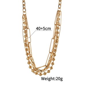 Detail showing 18K gold multilayer chain lengths and weights of the punk style necklace