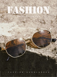 Detailed retro industrial sunglasses with gold metal frame on stone surface