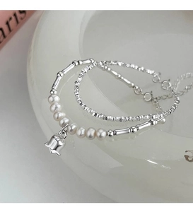 Detailed macro view of S925 silver bamboo joints and freshwater pearl tulip bracelet