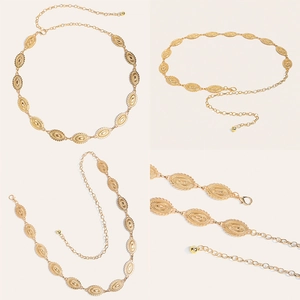Detail of vintage gold alloy waist chain showing ornate carved metal discs and lobster clasp