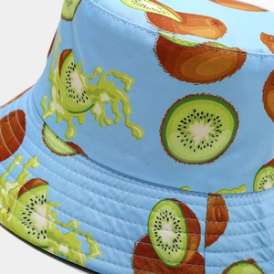 Detailed macro shot of kiwi fruit print and stitching on light blue cotton bucket hat
