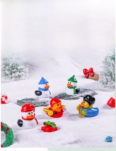 Miniature Christmas rubber ducks in winter sports scene with resin snow decor