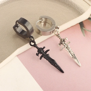 Macro shot of silver and black stainless steel hoop earrings with dagger pendants