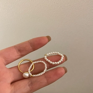 Detailed view of the three-piece gold finish ring set with freshwater pearls on hand