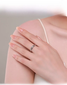Elegant model display of stacked silver cross rings with cubic zirconia on fingers