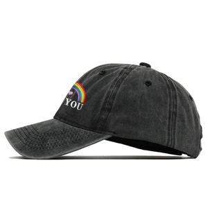 Detail view of the rainbow embroidery and BE YOU text on washed cotton baseball cap