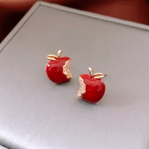 Exquisite 18k gold plated red apple stud earrings with crystals on a velvet base