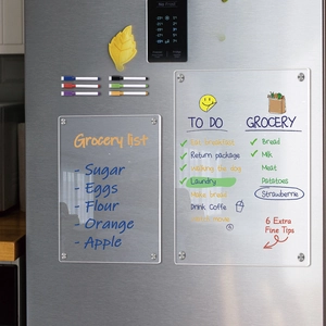 Detailed view of dual magnetic acrylic planners and color markers on a fridge