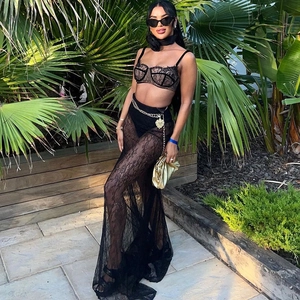 Detail of sexy black lace two-piece set with sheer fishnet skirt and gold chain belt