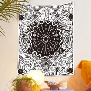 Detail of bohemian black and white tapestry with zodiac symbols and celestial patterns