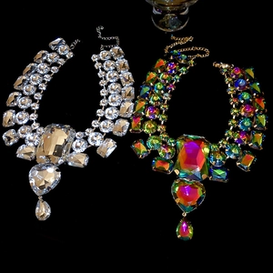 Macro detail of layered statement necklaces with heart and teardrop rhinestone pendants