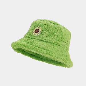 Detailed view of plush green bucket hat featuring a vibrant sunflower embroidery patch