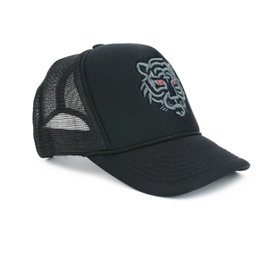 Detailed view of tiger embroidery and breathable mesh on a black trucker hat