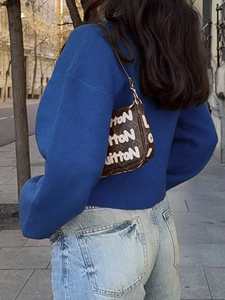 Brown knit sweater cardigan with white button details and long sleeves for winter