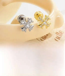 Macro shot of cross stud earrings in titanium steel with zircon crystals and screw back