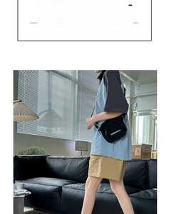 Close-up of Japanese style blue crew socks styled with khaki shorts and canvas bag