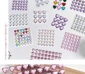 Macro detail of colorful 3D heart rhinestone stickers with multifaceted diamond cut effect
