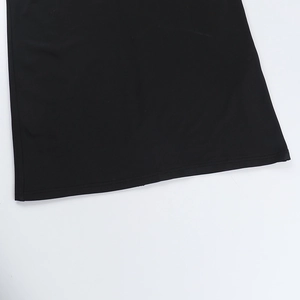 Detailed macro view of the black lace dress hemline showing high-quality stitching