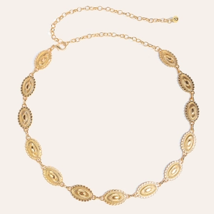 Close-up of vintage engraved oval gold metal links and adjustable chain of the waist belt