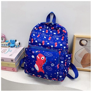 Close-up of royal blue toddler backpack with cartoon dinosaur prints on a nursery desk