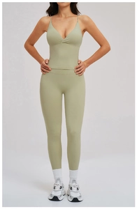 Detail view of light green high-waist yoga leggings and strappy V-neck sports bra set