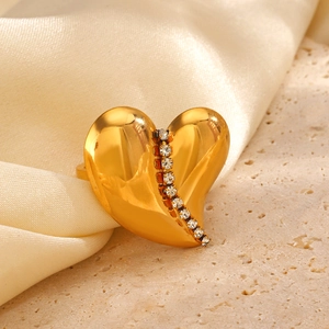 18K gold plated heart ring with sparkling rhinestones on elegant silk and stone background