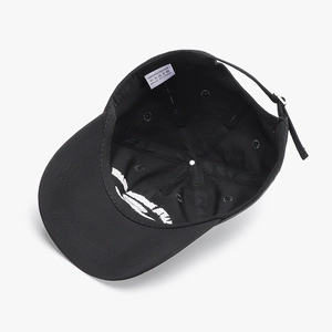 Internal view of a breathable black baseball cap showing 100% polyester fabric and lining