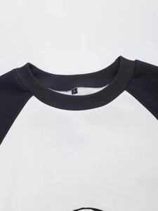Close-up of the round neckline and contrast raglan sleeves on this cotton sweatshirt