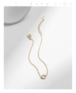 Detailed view of gold S925 sterling silver chain with a paved zircon ring charm